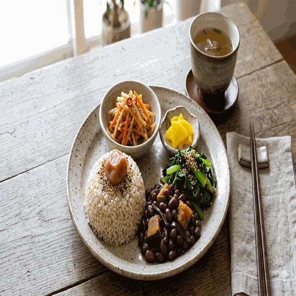 Macrobiotic midday plate with brown rice, adzuki beans, sautéed greens, kinpira and umeboshi